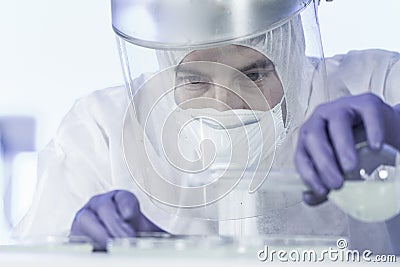 Life scientist researching in bio hazard laboratory. High degree of protection work. Stock Photo