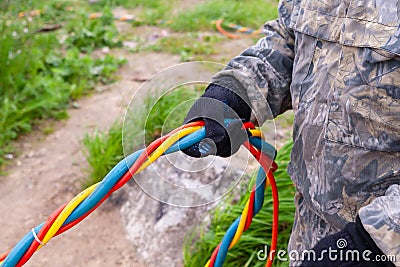 Life support hoses diver in the hands of an assistant on the shore Editorial Stock Photo