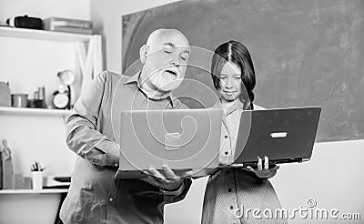 Life Time Career. small girl with man tutor study on computer. mature teacher help pupil girl. school lesson online Stock Photo