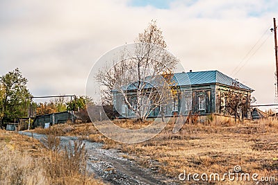 Life in the village, the road to housing for self-isolation in quarantine, one lonely suburban wooden secluded house on a hill in Stock Photo