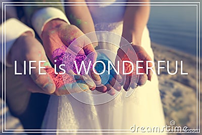 Life is Wonderful over hands with many colours. Stock Photo