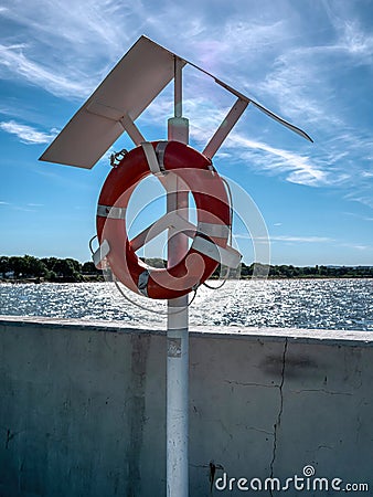 A lifebuoy hanging by the seashore Stock Photo