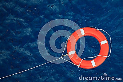 Lifebuoy in a stormy blue sea, safety equipment in boat. Stock Photo