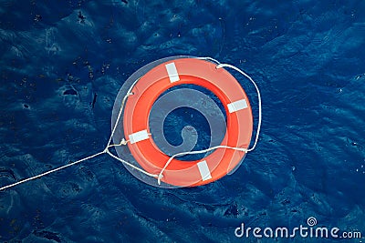 Lifebuoy in a stormy blue sea, safety equipment in boat. Stock Photo