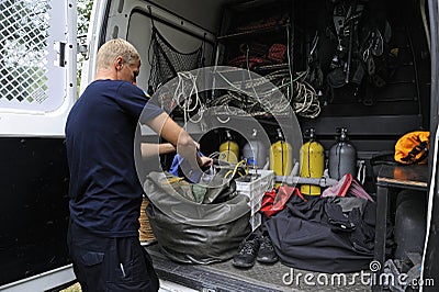 Lifeguard rescue diver preparing equipment for safeguarding people on a city beach. Rescue service, mobile rescue post Editorial Stock Photo