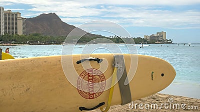 A lifeguard rescue surfboard at waikiki with diamond head in the distance Editorial Stock Photo