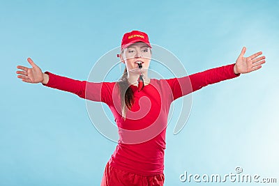 Lifeguard woman in cap on duty blowing whistle. Stock Photo