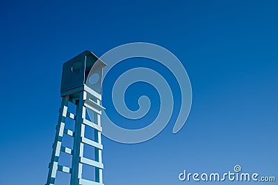 Lifeguard wooden rescue tower at the sea beach on blue sky Stock Photo