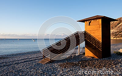 Lifeguard wooden tower at sunrise. Empty beach Pissouri Cyprus Stock Photo