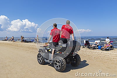 Lifeguards on ATVs driving along the coastline of the Baltic Sea in especially dangerous weather Editorial Stock Photo