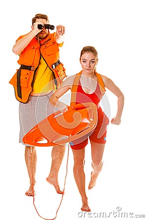Lifeguards in life vest with rescue buoy running Stock Photo
