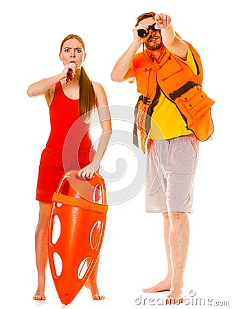 Lifeguards in life vest with rescue buoy whistling Stock Photo