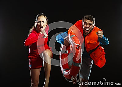 Lifeguards in life vest with ring buoy. Stock Photo