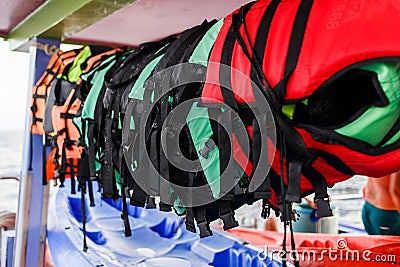 Lifejackets hanging on sea boat Stock Photo