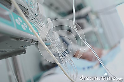 Lifelines in ICU on the background of patient in bed Stock Photo