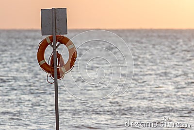 Lifesaver flotation ring. Beach lifebuoy ring on stand in front Stock Photo