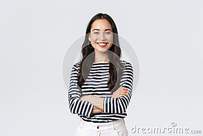 Lifestyle, beauty and fashion, people emotions concept. Young asian female office manager, CEO with pleased expression Stock Photo