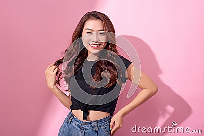 Lifestyle, beauty and people concept: Young cute smiling girl over pink background Stock Photo