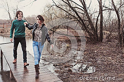 Lifestyle close up outdoor portrait of young happy loving couple walking in early spring Stock Photo