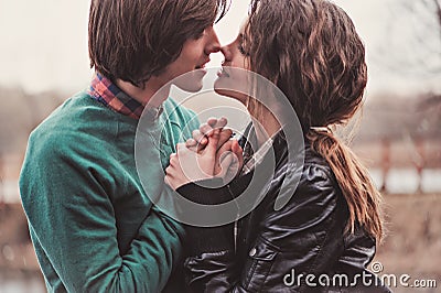 Lifestyle close up outdoor portrait of young loving couple kissing Stock Photo