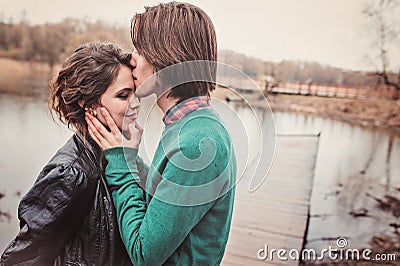 Lifestyle close up outdoor portrait of young loving couple kissing Stock Photo