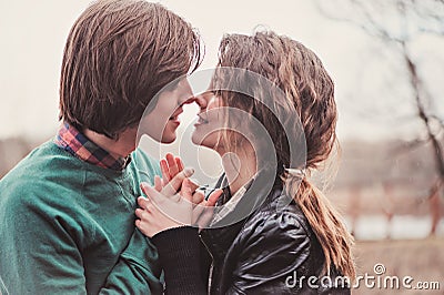 Lifestyle close up outdoor portrait of young loving couple kissing Stock Photo