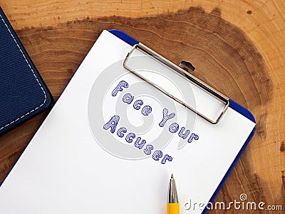 Lifestyle concept about Face Your Accuser with sign on the sheet Stock Photo