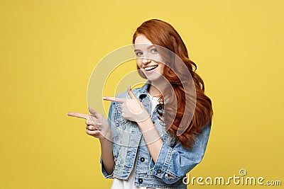 Lifestyle Concept: Happy excited cuacaisan tourist girl pointing finger on copy space isolated on golden yellow Stock Photo