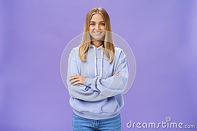 Portrait of charming charismatic european woman with tanned skin in trendy over-sized hoodie crossing hands against Stock Photo