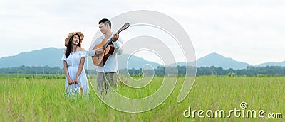 Lifestyle couple picnic sunny time. Asian young couple having fun and walking relax Stock Photo