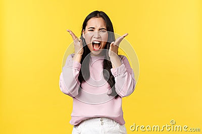 Lifestyle, emotions and advertisement concept. Angry distressed asian woman screaming hateful and outraged, feeling Stock Photo