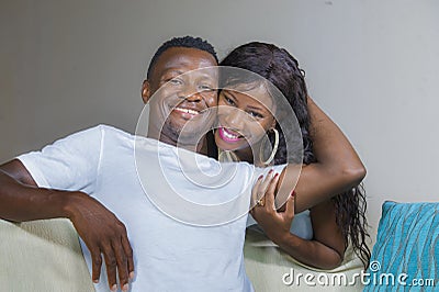 Lifestyle home portrait of young happy and successful romantic African American couple in love relaxed sitting comfortable Stock Photo