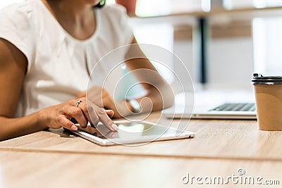 Lifestyle with modern woman using tablet or Ipad with hand holding touchscreen. Hands of working woman with Smart Tablet Stock Photo