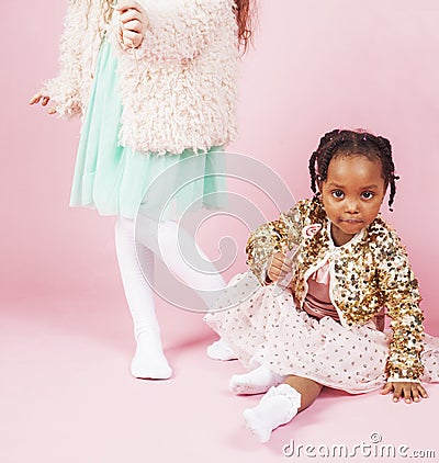 Lifestyle people concept: diverse nation children playing together, caucasian boy with african little girl holding candy Stock Photo