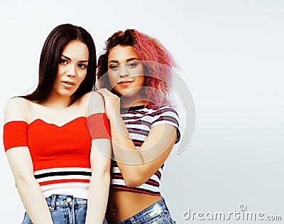 Lifestyle people concept: two pretty stylish modern hipster teen girl having fun together, diverse nation mixed races Stock Photo