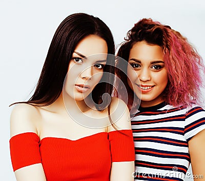 lifestyle people concept: two pretty stylish modern hipster teen girl having fun together, diverse nation mixed races Stock Photo