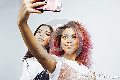 Lifestyle people concept: two pretty stylish modern hipster teen girl having fun together, diverse nation mixed races Stock Photo