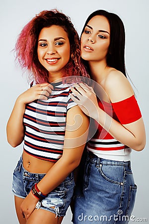 Lifestyle people concept: two pretty stylish modern hipster teen girl having fun together, diverse nation mixed races Stock Photo