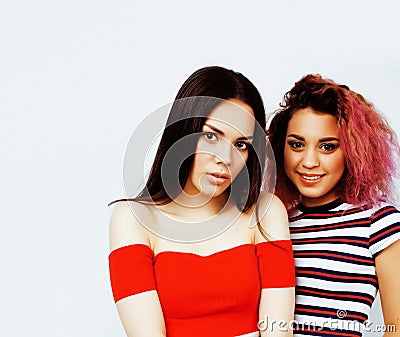Lifestyle people concept: two pretty stylish modern hipster teen girls having fun together, diverse nation mixed races Stock Photo