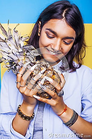 Lifestyle people concept. young pretty smiling indian girl with pineapple, asian summer fruits Stock Photo