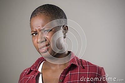 Lifestyle portrait if young unhappy and pretty afro American woman in contempt and disgust face expression as if disliking or find Stock Photo