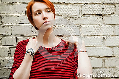 Lifestyle portrait of young adult white woman in stripped shirt Stock Photo