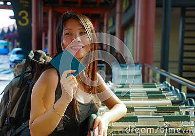 Lifestyle portrait of young happy and attractive Asian Korean woman with backpack smiling excited and playful at airport arrival Stock Photo