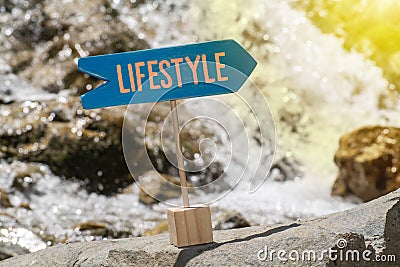 Lifestyle sign board on rock Stock Photo