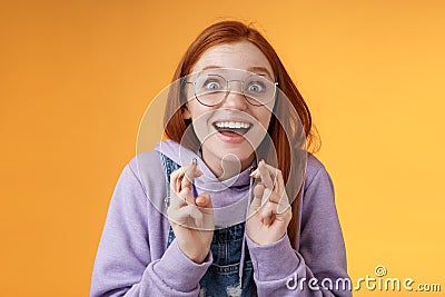 Surprised girl dream came true celebrating standing amused excited cross fingers good luck wish fulfilled smiling Stock Photo