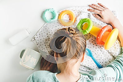 Lifestyle tired mother top view on white background Stock Photo