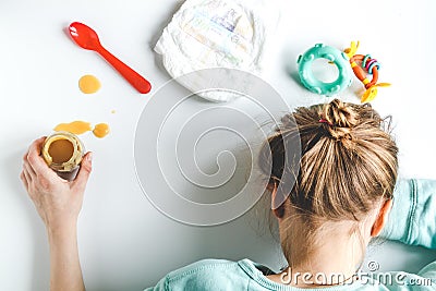 Lifestyle tired mother top view on white background Stock Photo