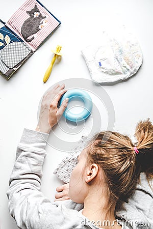 Lifestyle tired mother top view on white background Stock Photo