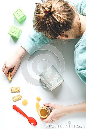 Lifestyle tired mother top view on white background Stock Photo