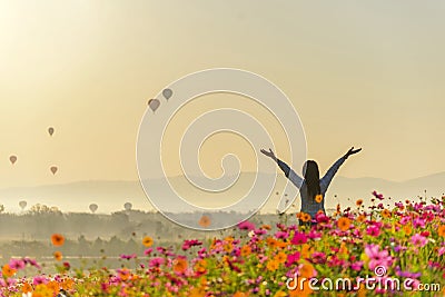 Lifestyle traveler women raise hand feeling good relax and happy freedom and see the fire balloon Stock Photo